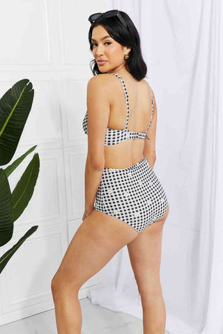 In a variety of colors and prints, this high-waisted bikini is sure to meet everyone's taste. The twist-front top is flirty and the high-rise bottoms are flattering.Marina West Swim Take A Dip Twist High-Rise Bikini in BlackPGST