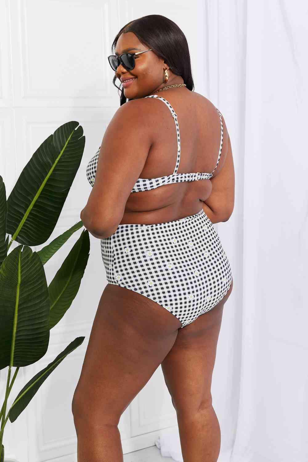 In a variety of colors and prints, this high-waisted bikini is sure to meet everyone's taste. The twist-front top is flirty and the high-rise bottoms are flattering.Marina West Swim Take A Dip Twist High-Rise Bikini in BlackPGST