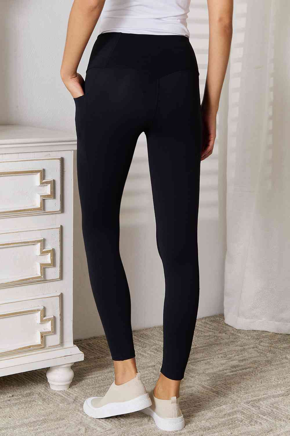 Wide waistband sports leggings are a comfortable and functional choice for athletic activities. The wide waistband provides extra support and coverage, ensuring a seBasic Bae Wide Waistband Sports LeggingsPGST