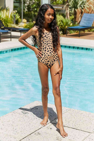 This one-piece swimsuit is ideal for outdoor and beach activities. It features a printed design and ruffle detailing, adding a stylish touch. This swimsuit is perfecMarina West Swim Float On Ruffled One-Piece in LeopardPGST