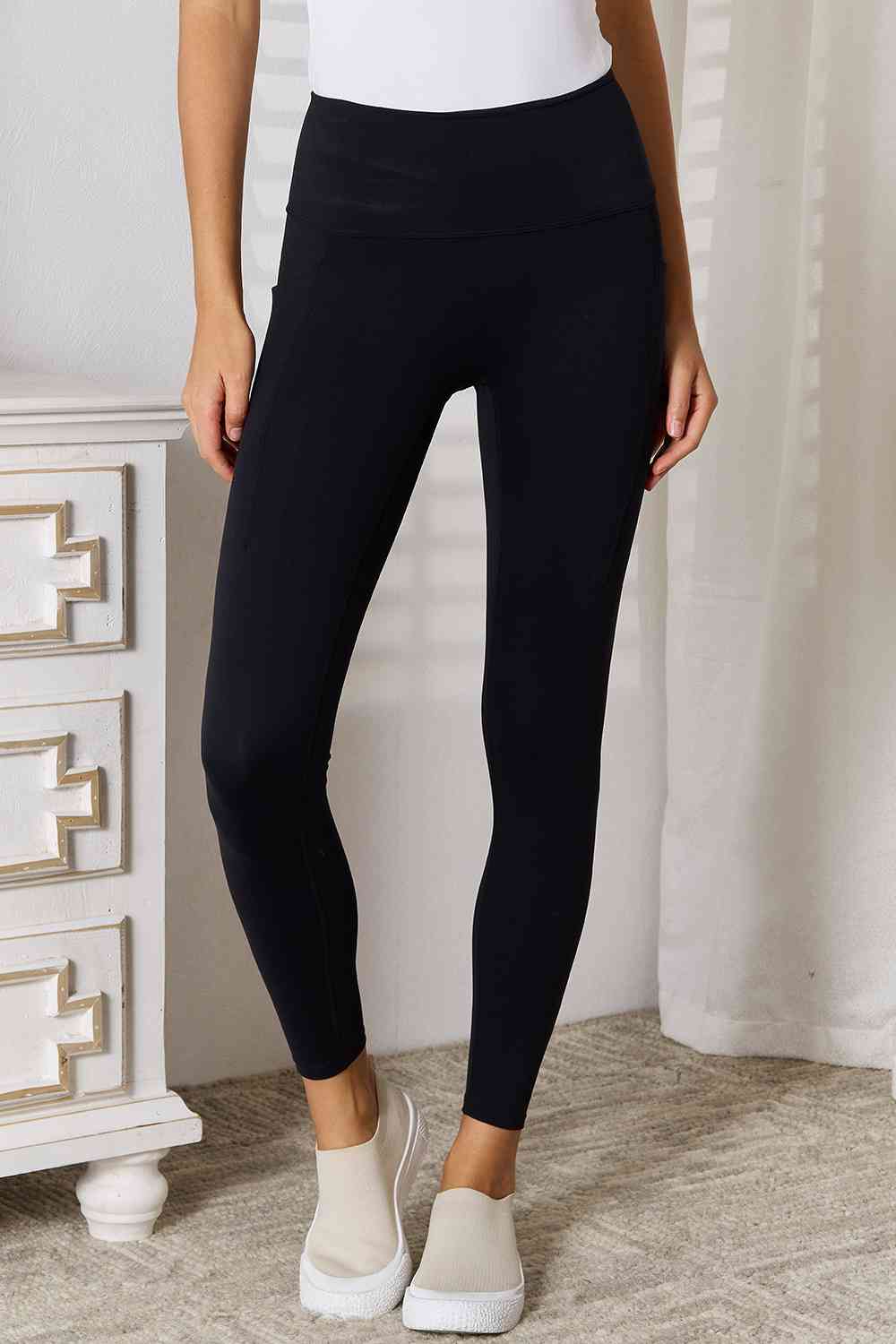 Wide waistband sports leggings are a comfortable and functional choice for athletic activities. The wide waistband provides extra support and coverage, ensuring a seBasic Bae Wide Waistband Sports LeggingsPGST