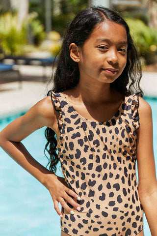 This one-piece swimsuit is ideal for outdoor and beach activities. It features a printed design and ruffle detailing, adding a stylish touch. This swimsuit is perfecMarina West Swim Float On Ruffled One-Piece in LeopardPGST